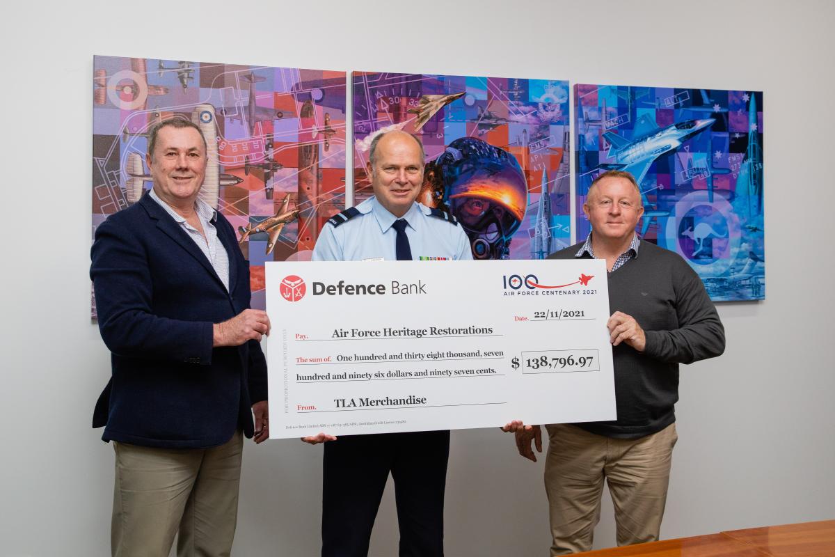 CEO of The Air Force Shop Stephen Davie, left, Director General Air Force 2021 Air Commodore Andrew Elfverson and General Manager TLA Merchandise Terry Wilson at the presentation of funds raised through Air Force centenary merchandise sales.