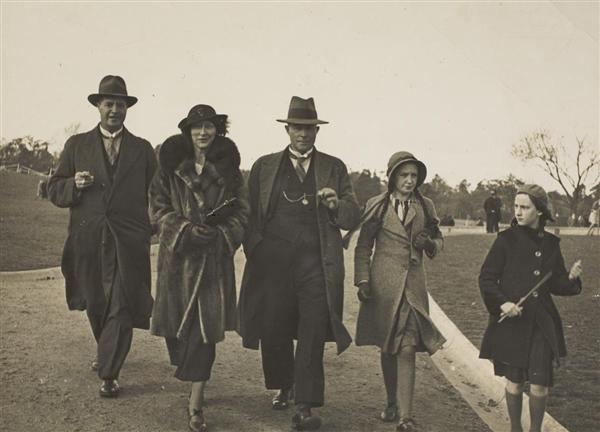 Black and white photograph showing the Allen family in Melbourne on ANZAC Day, 1935 or 1936. They have watched the ANZAC Day march and are walking to the ceremony at the Shrine of Remembrance in the King's Domain parklands, adjacent to St Kilda Road.