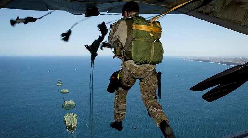 An Australian soldier from 1st Commando Regiment jumps from a Royal Australian Air Force C-130J Hercules aircraft during annual parachute certification off Manly Beach.