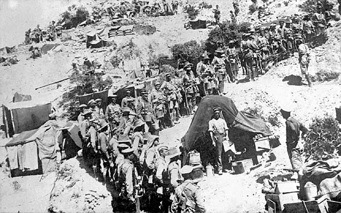 A platoon of the 13th Battalion, 4th Brigade, AIF, awaits an address by its commander Captain Joseph Lee, in the Sphinx Gully, Gallipoli probably prior to the brigade’s night march on 6–7 August 1915 to attack Kocitemenepe.