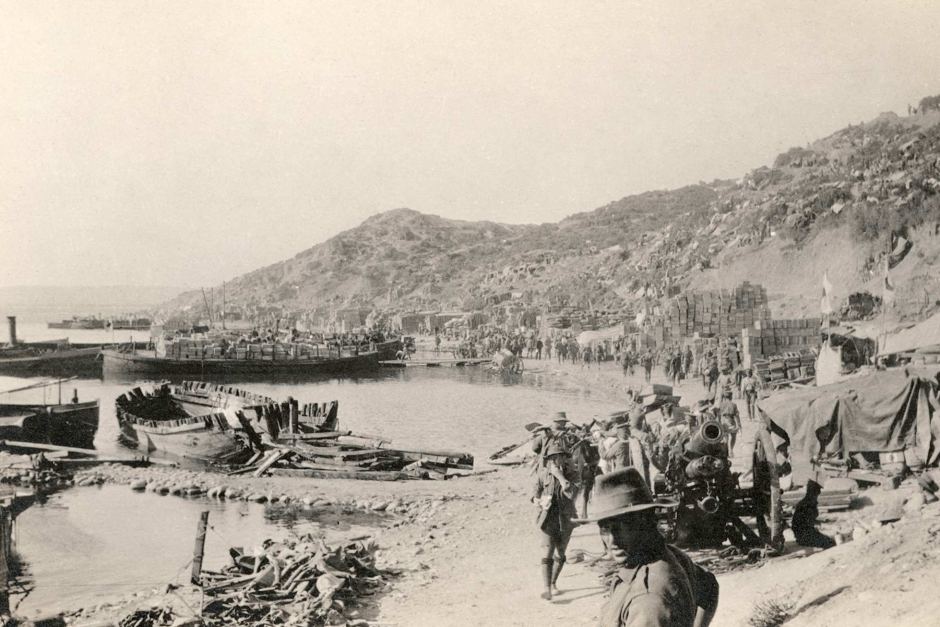 Image: The beach at Anzac Cove, 1915 referred to as "a shell-torn strip of beach".