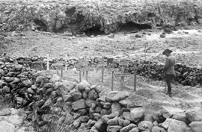 Image: An Australian officer visits a comrade's grave on Gallipoli.