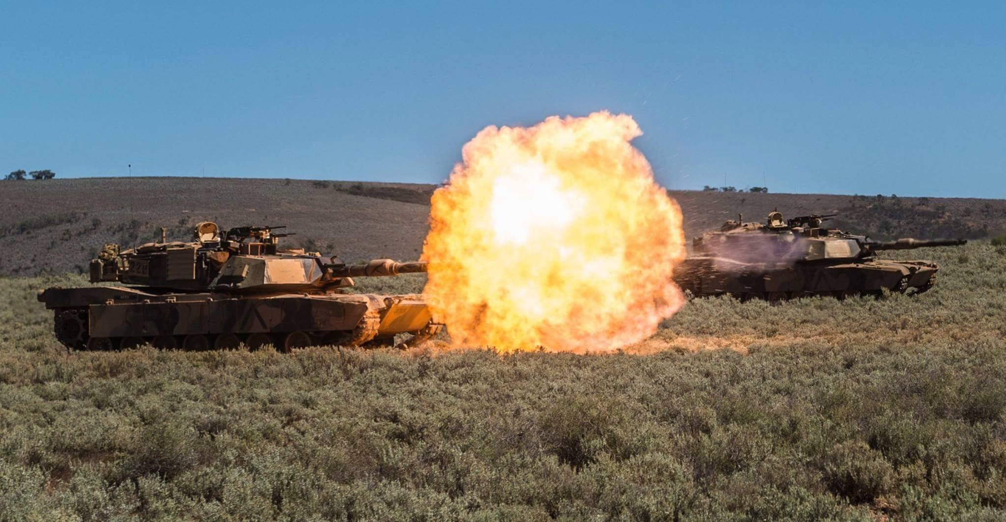 Tanks from Battle Group Lion roar onto the objective during Exercise Predator's Gallop 16.