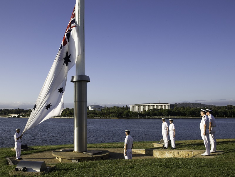 The Navy Ensign is raised in Canberra